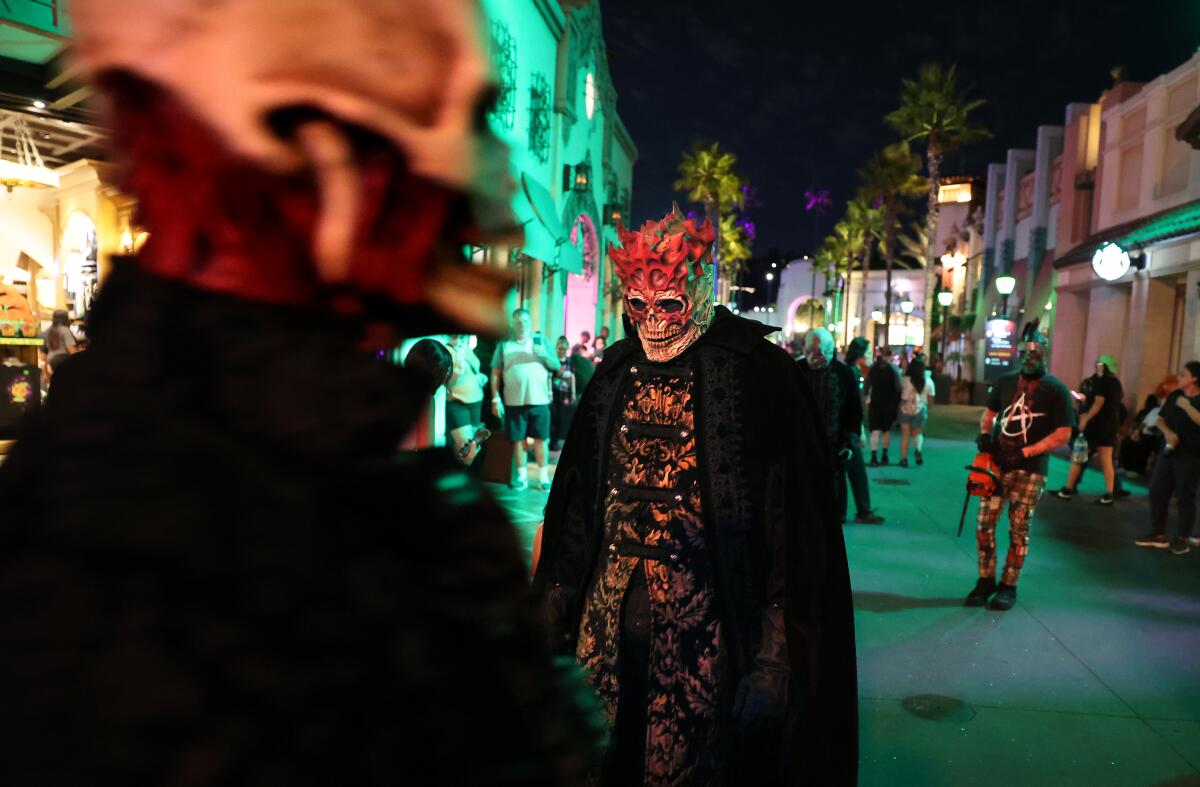 Costumed scare actors at a theme park Halloween event. 