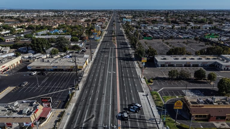 An aerial view shows a police checkpoint enforcing a road...