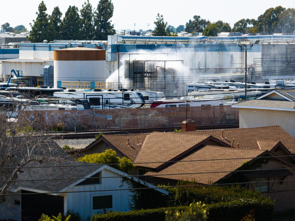 An aerial of water being sprayed on large storage tanks at the GKN Aerospace facility in Garden Grove