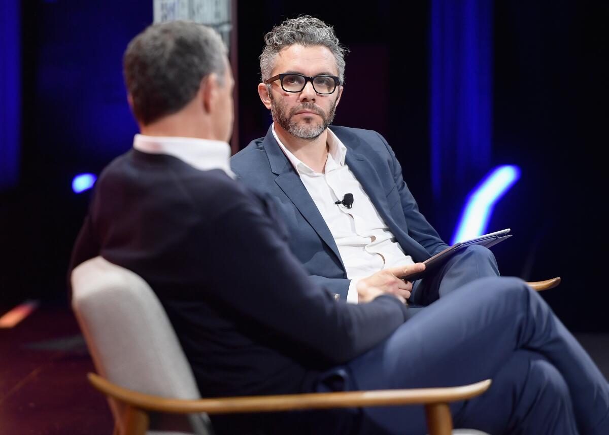 Chairman and CEO of Disney Robert A. Iger, left, and special correspondent at Vanity Fair Nick Bilton speak onstage