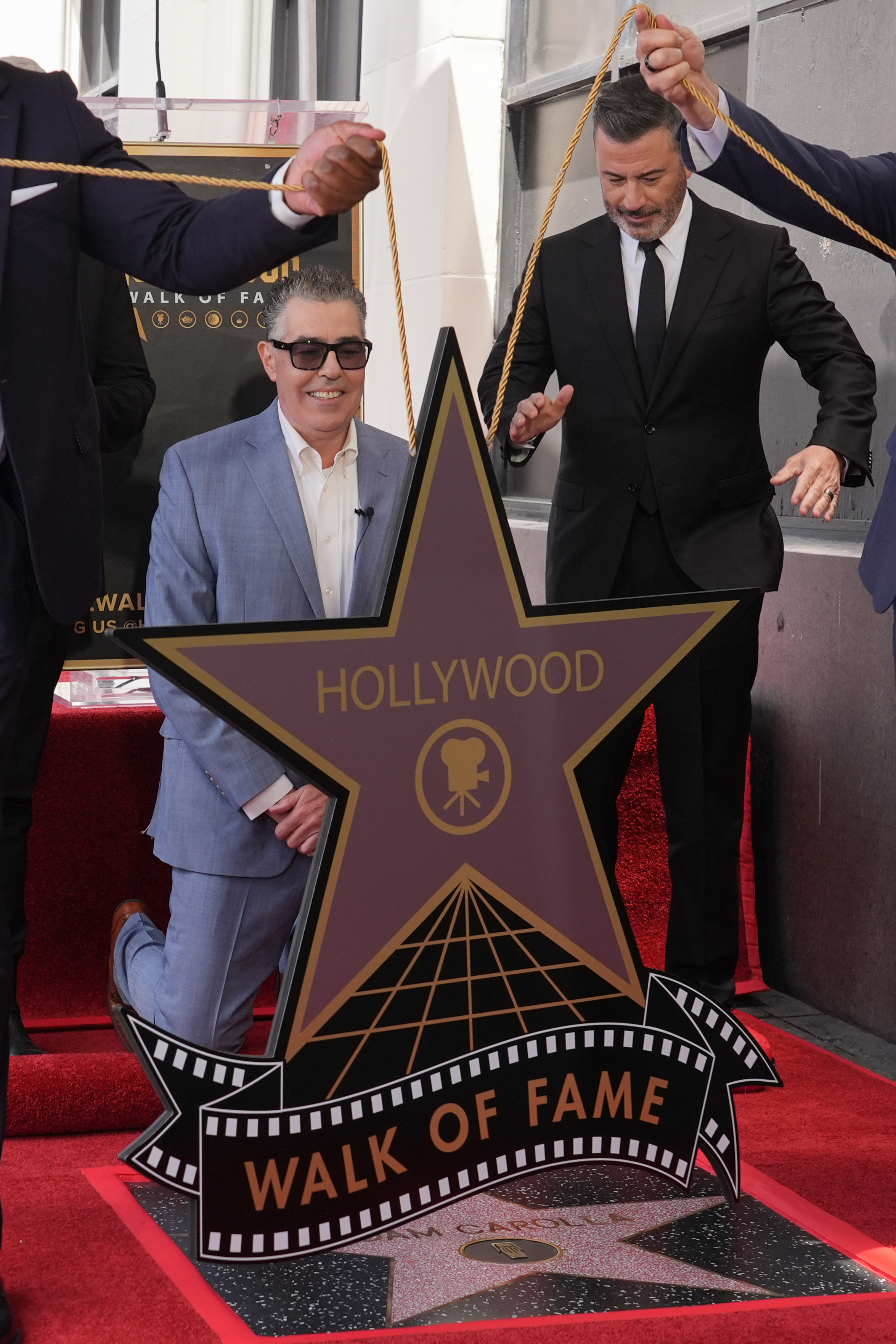 Adam Carolla, left, and Jimmy Kimmel pose with Carolla’s new...