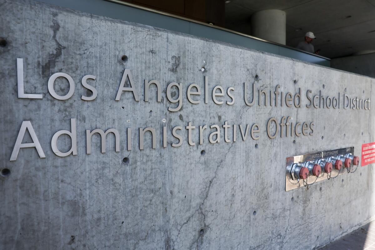 Words on a wall say "Los Angeles Unified School District, Administrative Offices."