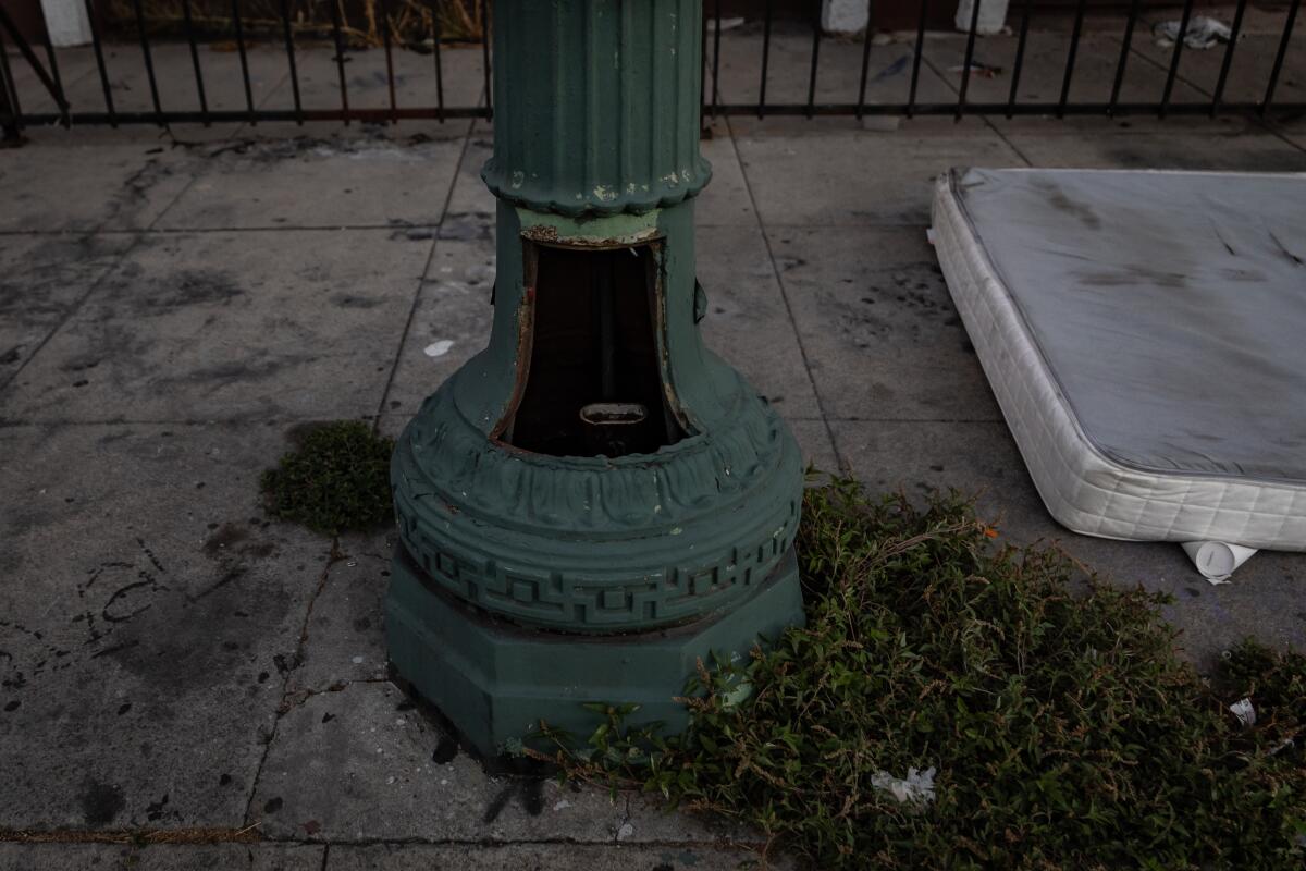 A metal pole and base, with an opening in the base.