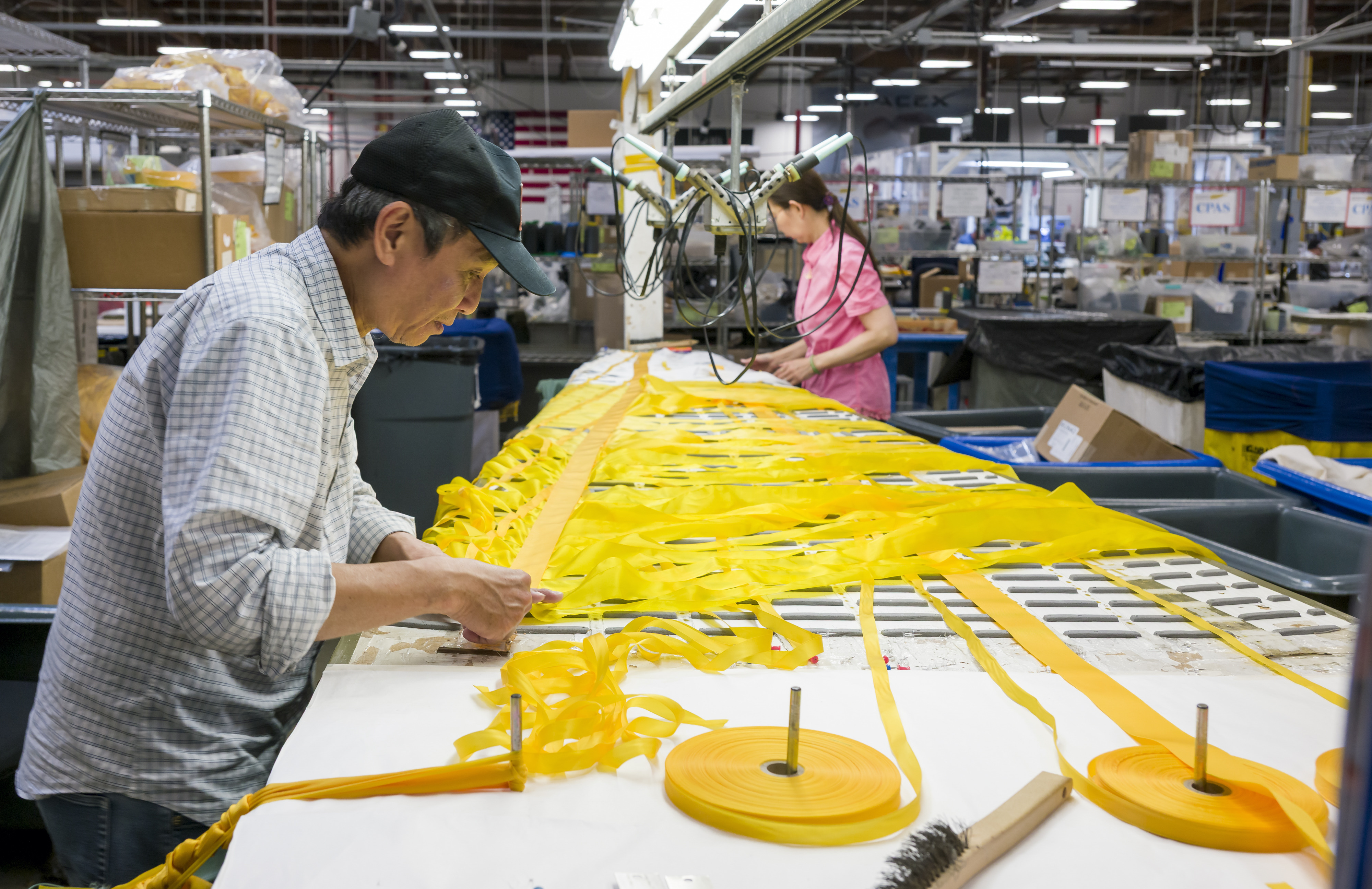 Workers, Hue Truong, left, and Vinh Long Nguyen, assemble ribbon...