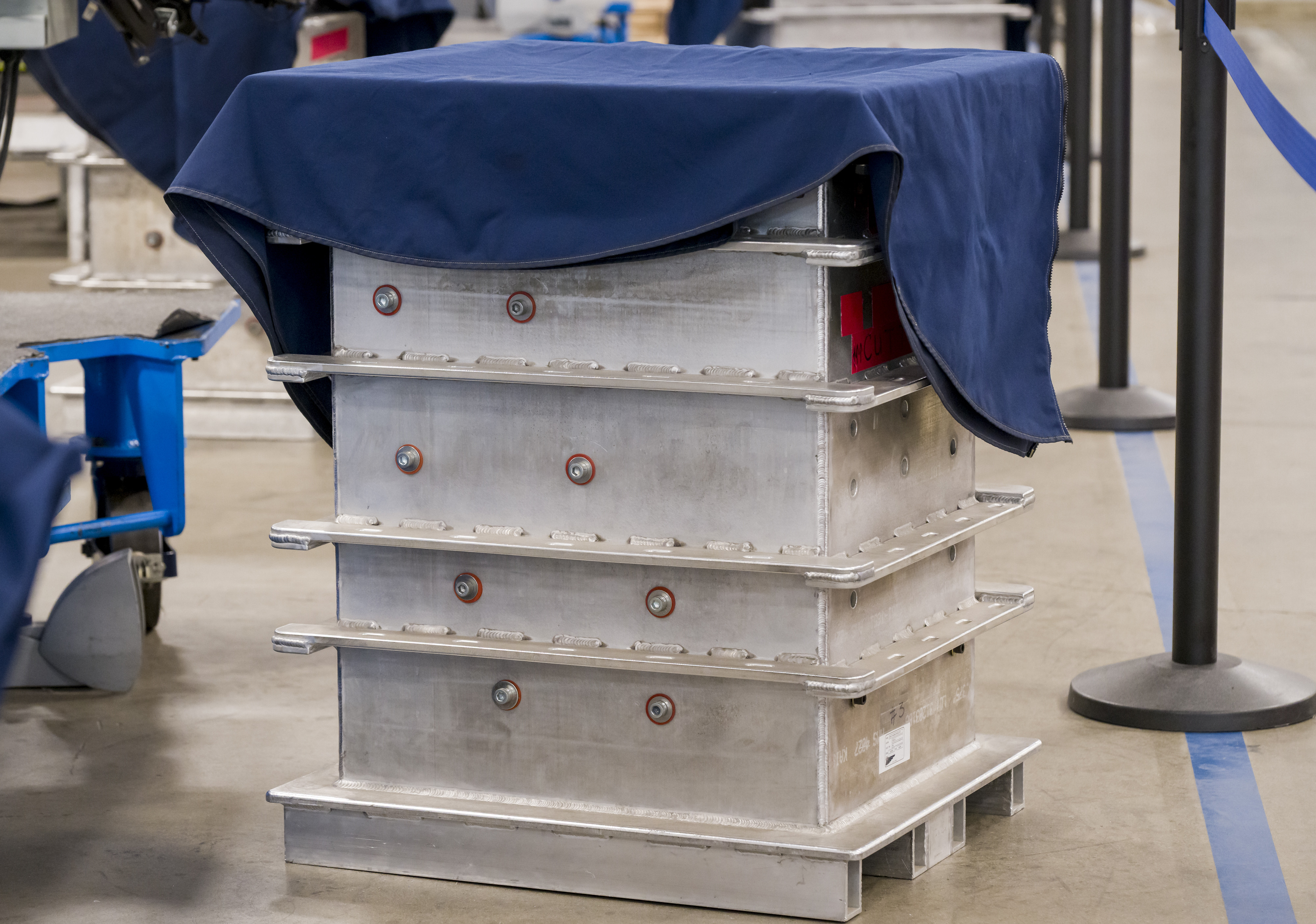 Hydraulic presses folded parachutes into these boxes as part of...