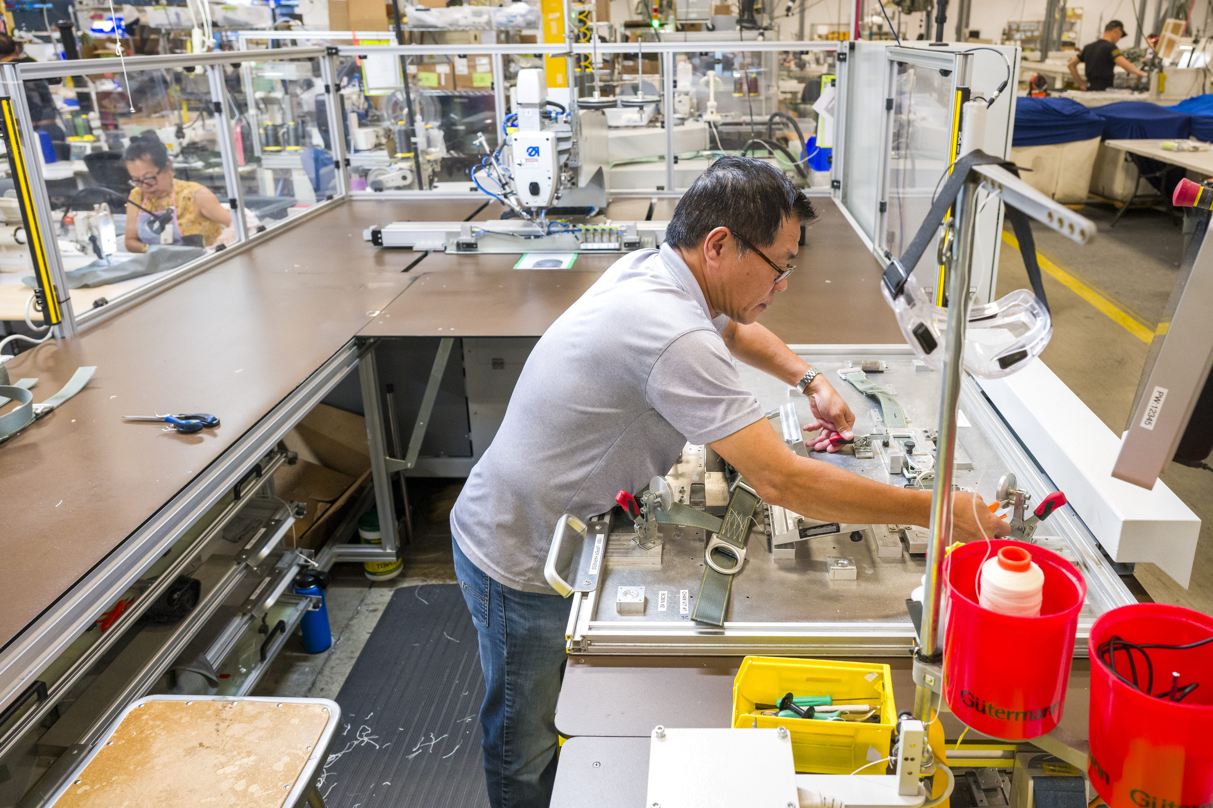 Assembler Quoc Anh Nguyen works on an automated pack tray...