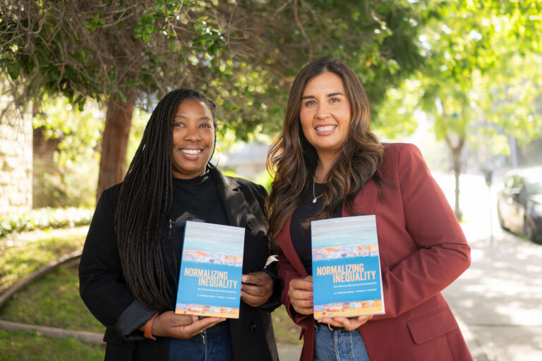 Two women in professional attire, one Black and one Latina, hold up copies of a book with the title Normalizing Inequality.