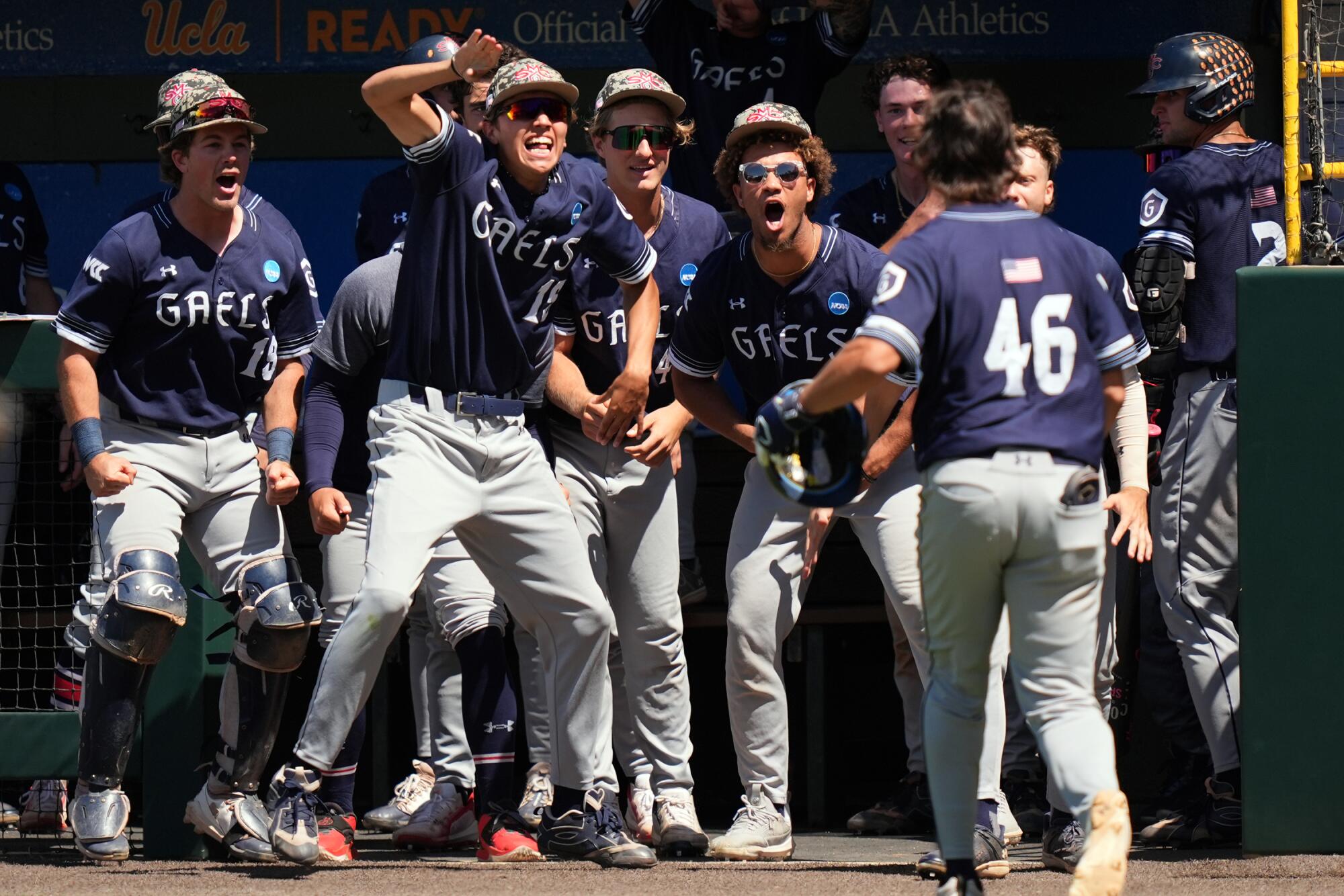 Saint Mary's Jacob Johnson (46) celebrates with teammates after hitting a go-ahead solo home run.