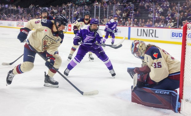 Minnesota Frost forward Kendall Coyne Schofield (26) and Montréal Victoire defenseman Kati Tabin (9) watch as Victoire goaltender Ann-Renée Desbiens (35) stops a shot during game 4 of the PWHL semifinals at the Grand Casino Arena on May 8, 2026, in St. Paul, MN. The Frost beat the Victoire 3-1. (Stacey Wescott/Chicago Tribune)