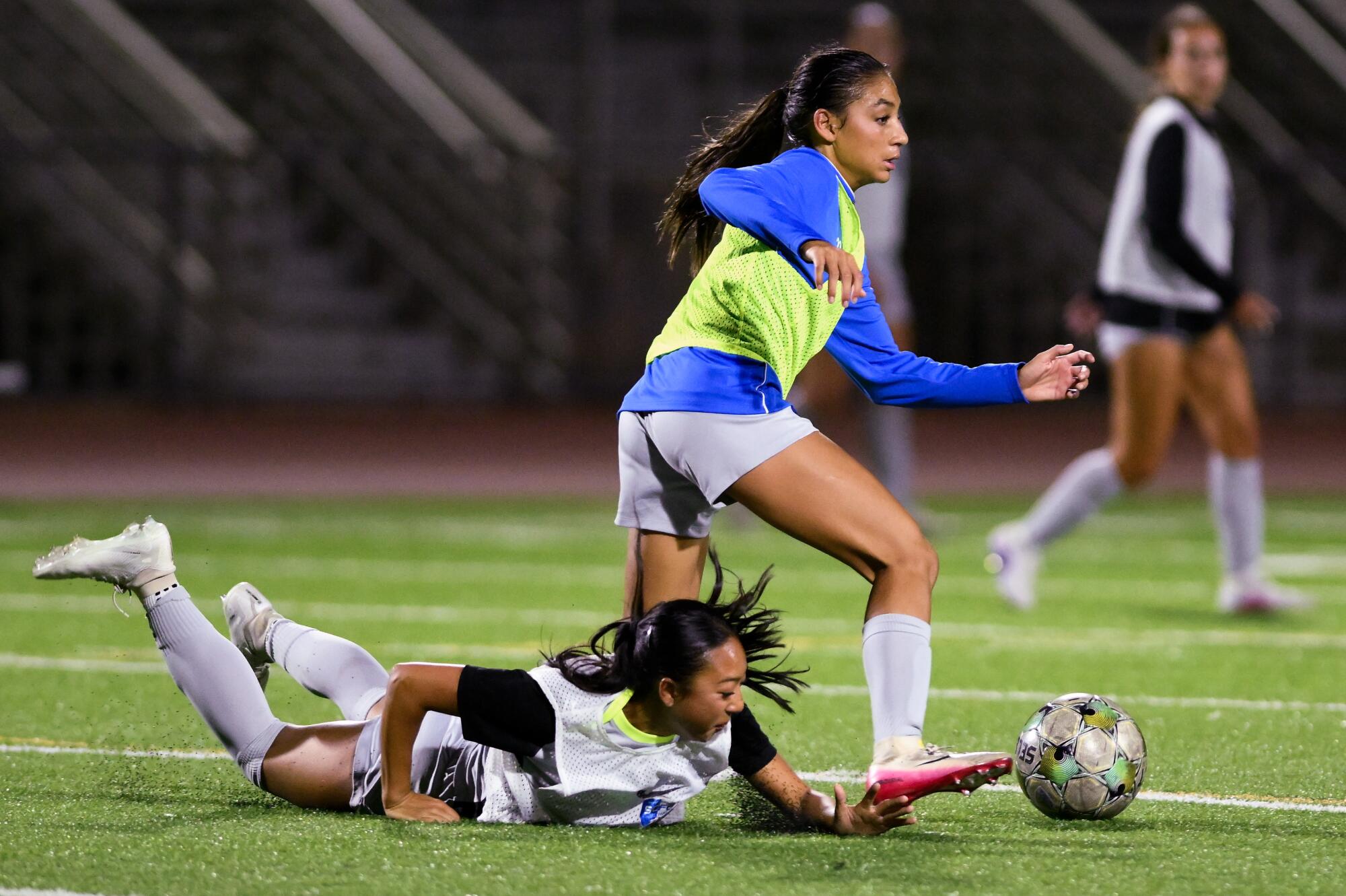 Zoe Thompson drives the ball past a teammate during a training session.