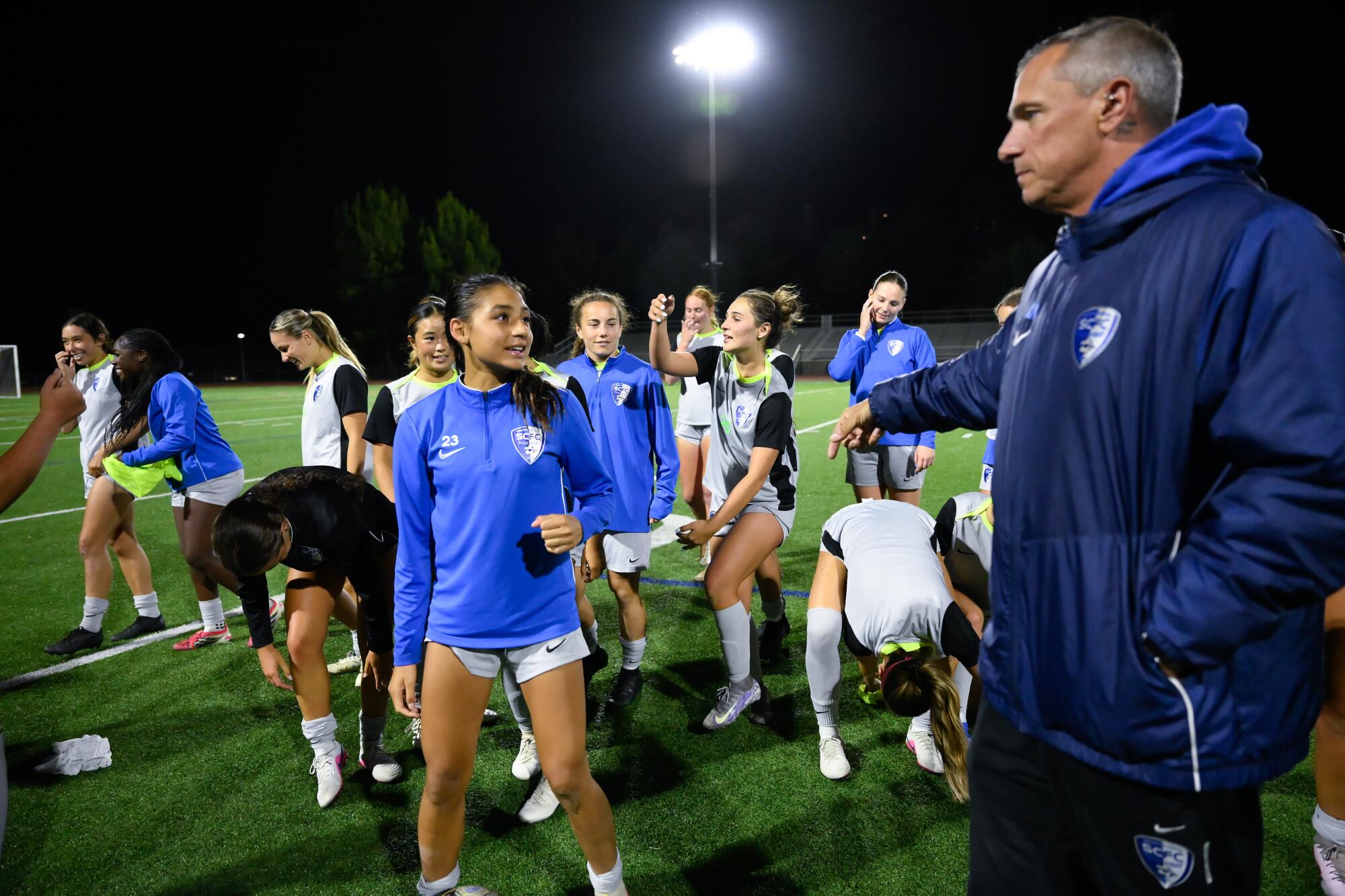 Zoe Thompson with head coach Leonardo Neveleff at the conclusion of a training session.