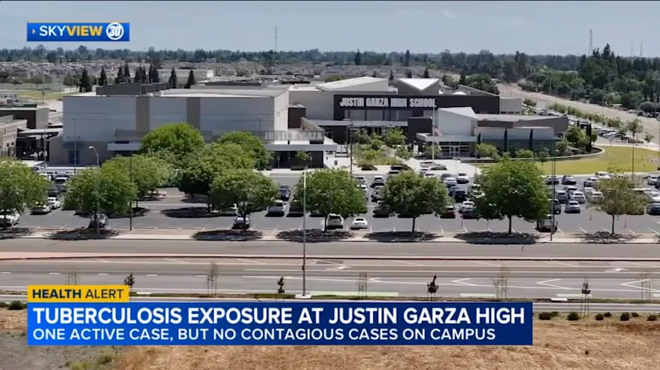 An aerial view of Justin Garza High School, with a news chyron at the bottom reporting a tuberculosis exposure. ABC 30