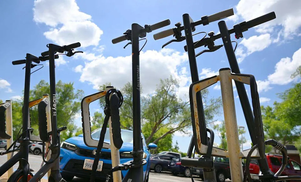 Motorized scooters are seen locked outside Fresno State's Lynda and Stewart Resnick Student Union Monday, April 27, 2026 in Fresno.
