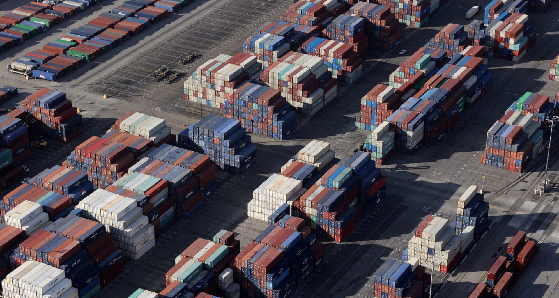 Shipping containers sit on the dock at a container terminal at the Port of Long Beach-Port of Los Angeles complex