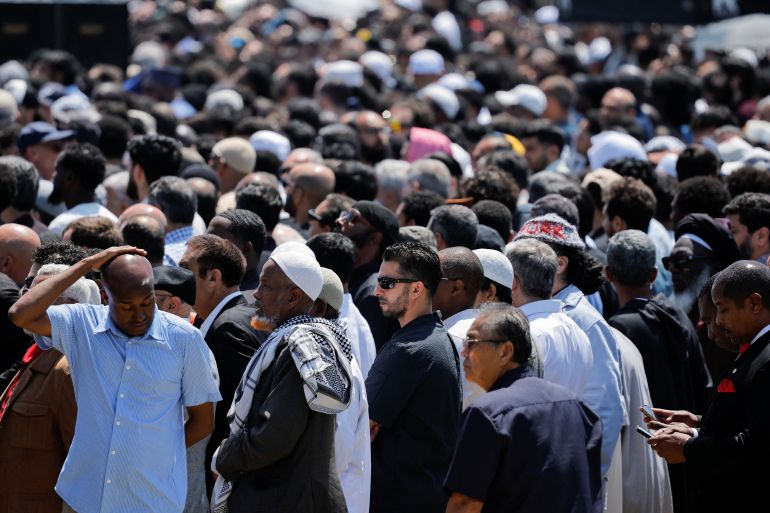 Men arrive at a prayer service for the victims of a shooting at the Islamic Center