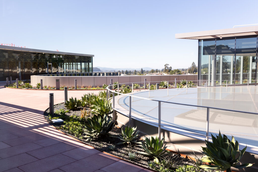 View from the rooftop terrace of the Barbara and Gerson Bakar Gateway, home of the UC Berkeley College of Computing, Data Science, and Society, featuring a large glass skylight.