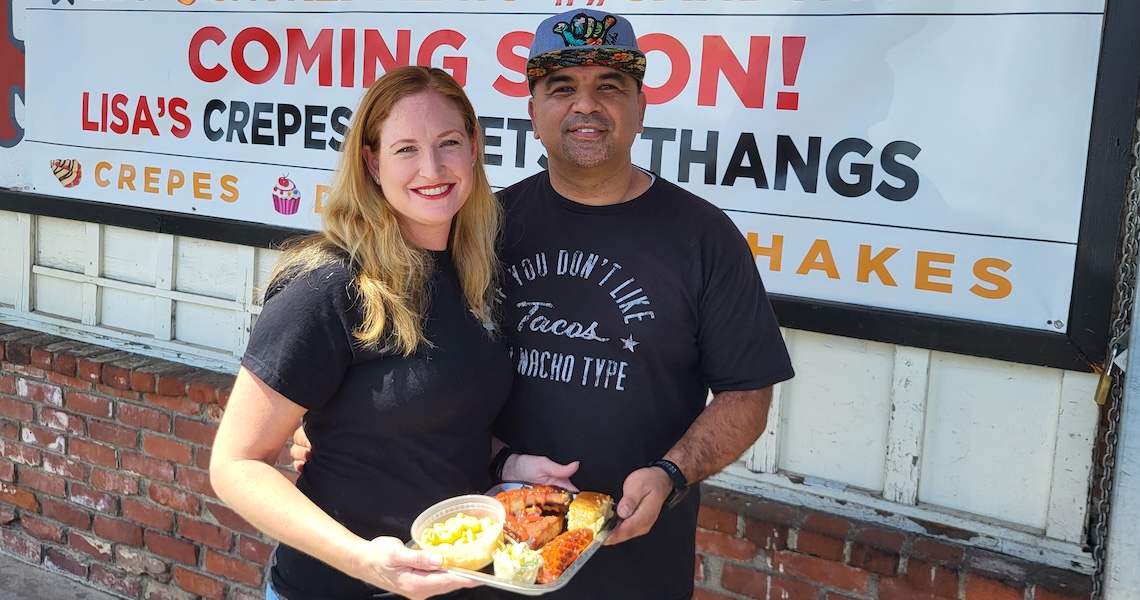 a couple holding a bbq plate
