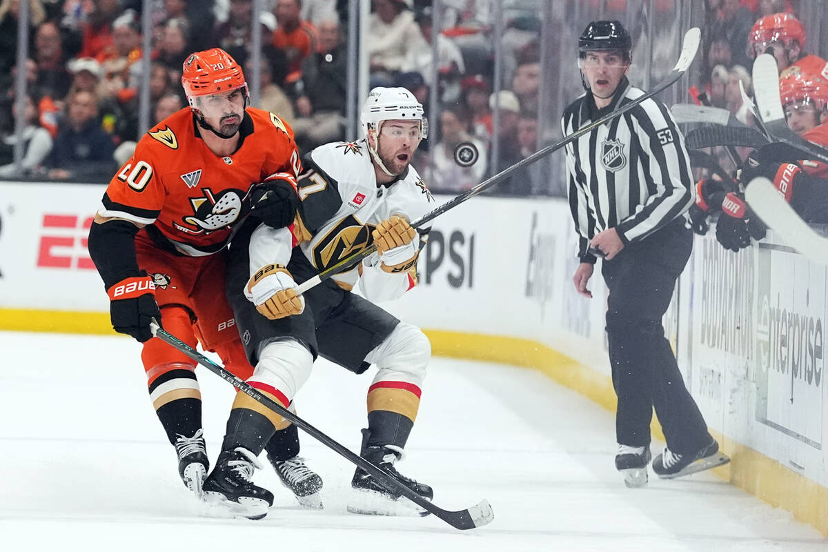 Vegas Golden Knights' Ben Hutton (17) and Anaheim Ducks' Chris Kreider (20) vie for t ...
