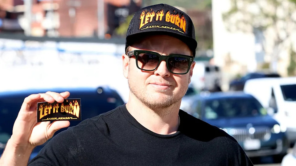 Spencer Pratt wearing a Newsom hat and sticker in Pacific Palisades, California