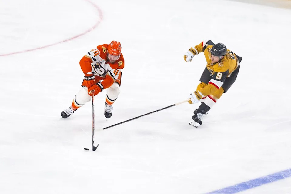 Anaheim Ducks left-wing Ross Johnston (44) skates the puck up the ice as Vegas Golden Knights center Jack Eichel (9) attempts to poke check the puck during game 2 of a NHL playoff game between the Vegas Golden Knights and the Anaheim Ducks, Wednesday May 6, 2026 in Las Vegas, Nev.