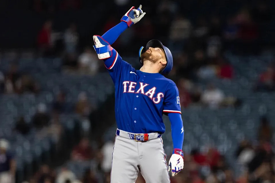 Brandon Nimmo #24 of the Texas Rangers celebrates after hitting a double during an MLB game against the Los Angeles Angels on May 23, 2026 at Angel Stadium in Anaheim, California.