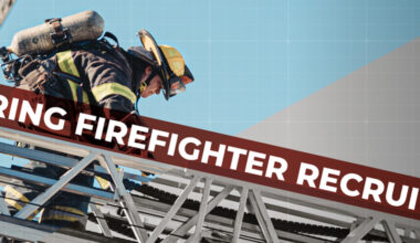 A firefighter recruit walking on an aerial ladder.