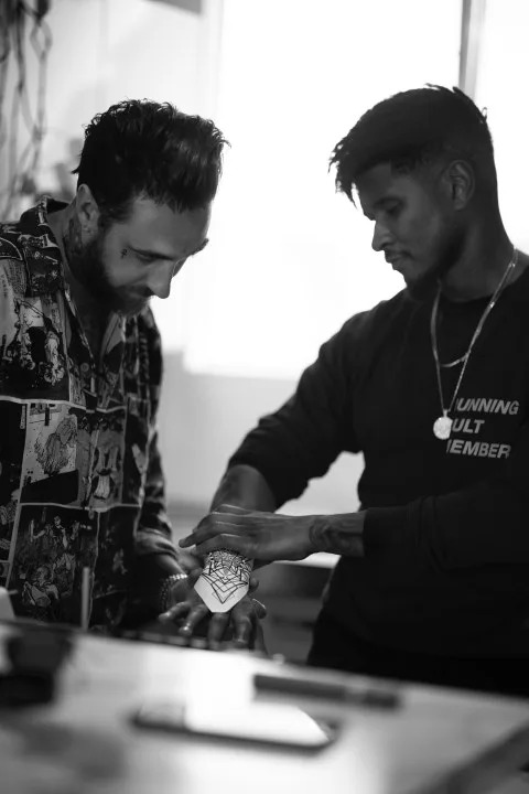 Dillion Forte and singer Usher collaborating over a tattoo. (Courtesy of Dillon Forte)
