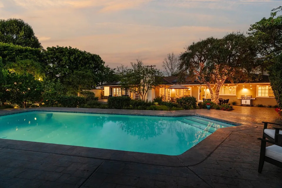 Outside, the grounds continue the resort-like feel with amenities designed for both entertaining and everyday relaxation, including the sparkling pool, fruit tees, and solar panels. <span class="image-credit">(Neue Focus)</span>
