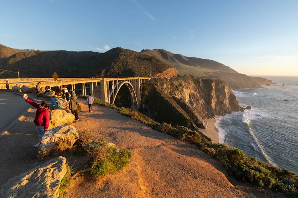 Tourists taking photos of Bixby Bridge and the Big Sur coastline. Los Angeles Times via Getty Images