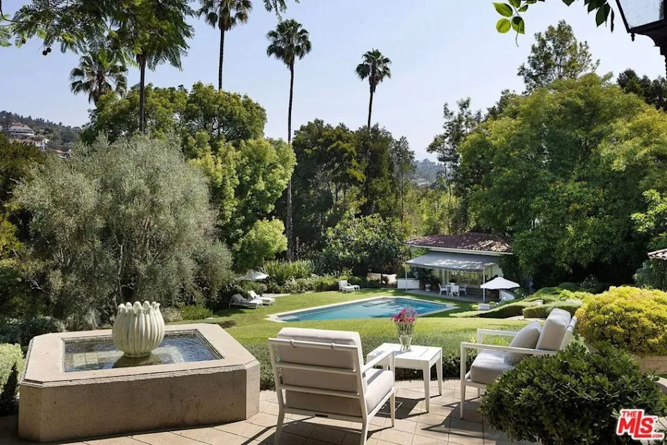 Among the upscale amenities that are mentioned in the description are a fitness studio, a tea house, a guest house studio with its own living room, fireplace, and private gated entry, and a pool house, as well as a “separate garage with security station.” Andrew Bramasco / Realtor.com