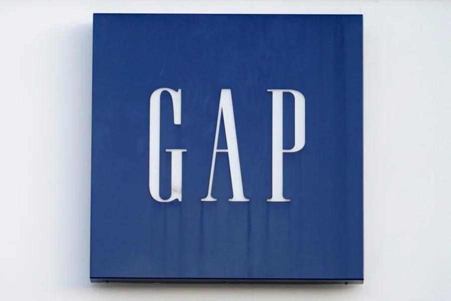 A Gap logo hangs on the exterior of a Gap clothing store, Thursday, Feb. 25, 2021, in Dedham, Mass. (AP Photo/Steven Senne)