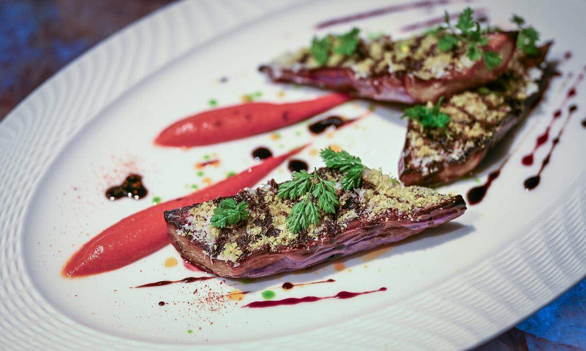 A fire-roasted eggplant dish is plated at Bulle, a new high-end restaurant in northwest Fresno that features farm-to-table dining with a focus on sustainability, in-house dry-aged meats and seasonal produce.