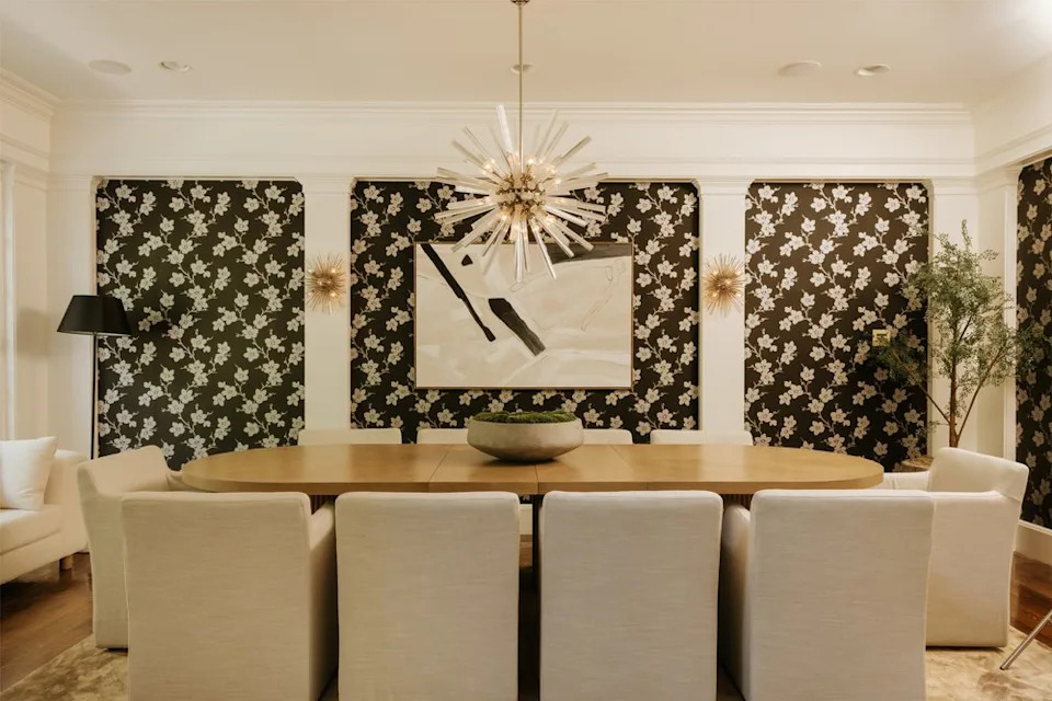 For more upscale dining, there is a beautiful formal dining room that features a large table, patterned floral wallpaper, and a unique spiked chandelier that hands at the center of the space. <span class="image-credit">(Christian Cruzio Studios)</span>