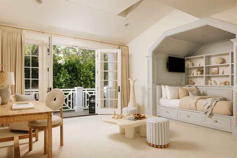 Another bedroom on the second story of the home appears to have been used by one of the couple's children, with a cozy bed set into an alcove that has been outfitted with custom built-ins, as well as its own TV. <span class="image-credit">(Christian Cruzio Studios)</span>