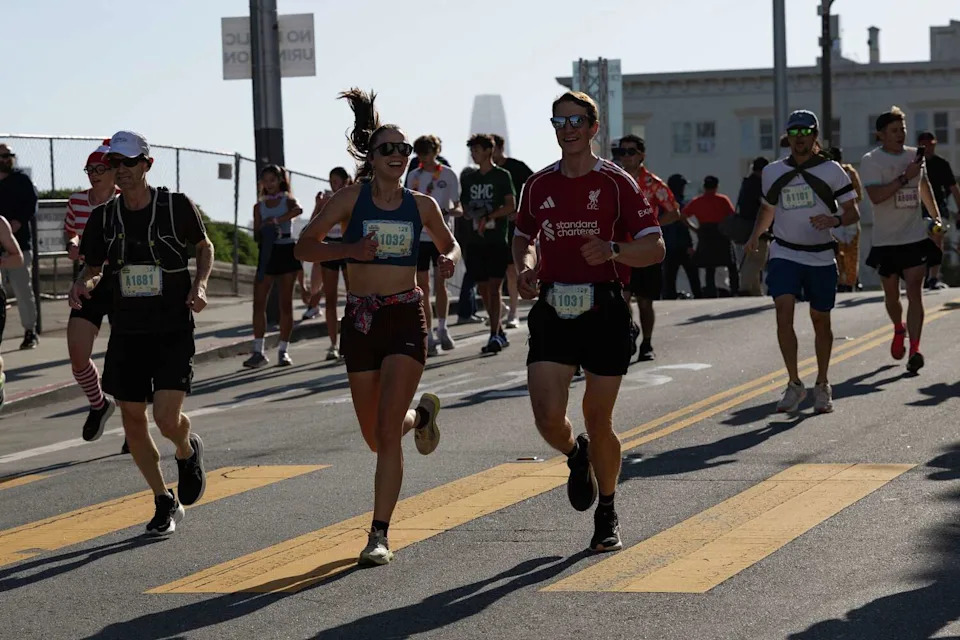 Runners descend Alamo Square during the 113th annual Bay to Breakers in San Francisco on Sunday. (Benjamin Fanjoy/For the S.F. Chronicle)