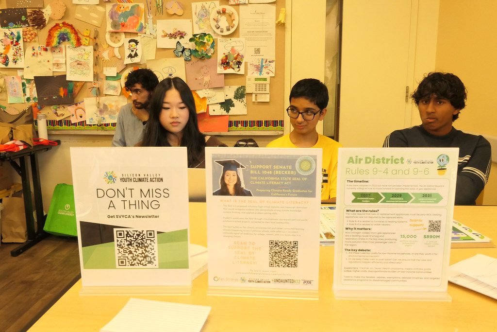 Four students sit at a table