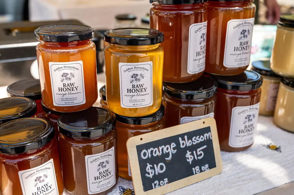 Golden Honeybees jarred honey at Meadowview Farmers’ Market in Sacramento on June 23, 2024. The family-owned honey business also sells honeycomb from their West Sacramento farm.
