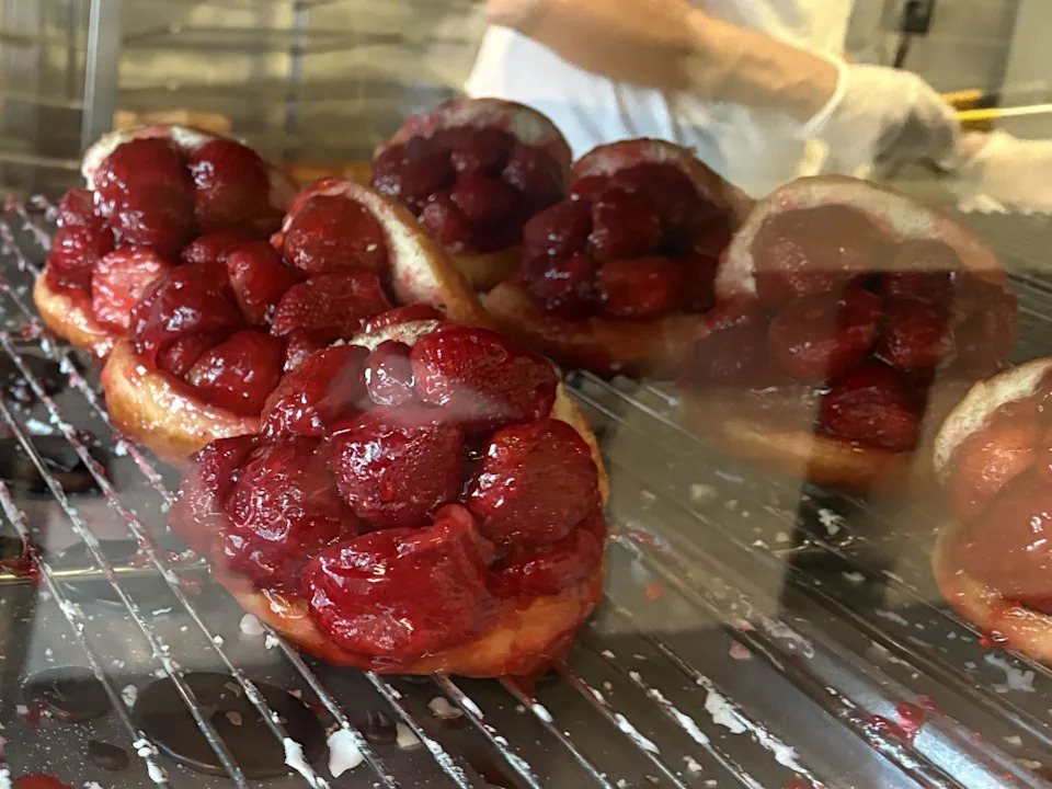 A glass case with strawberry stuffed doughnuts from Donut Man