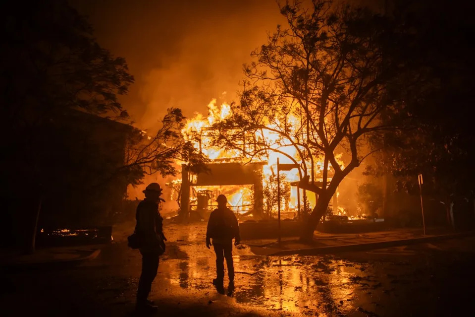 Firefighters battle the Palisades Fire as it burns during a windstorm on the west side of Los Angeles, California. Getty Images