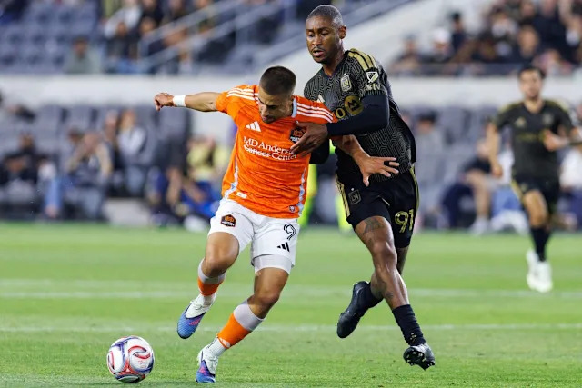 Ondrej Lingr #9 of Houston Dynamo FC gets fouled by Nkosi Tafari #91 of LAFC during an MLS match against LAFC on May 10, 2026 at BMO Stadium in Los Angeles, California.