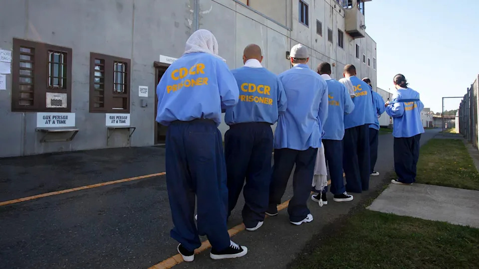 California prison inmtes line up outside.