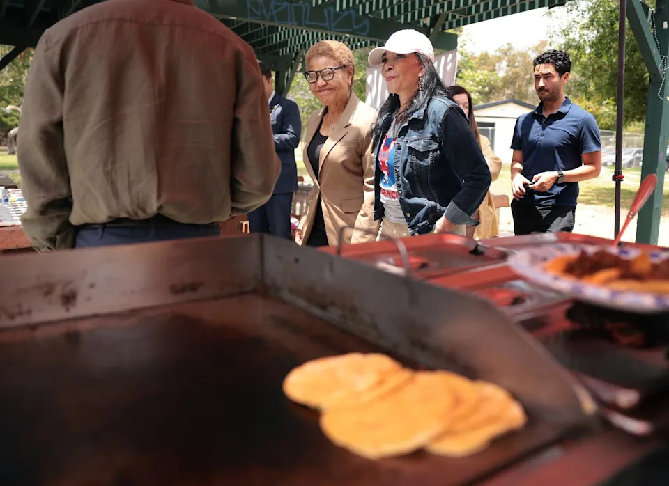 Mayor Karen Bass walks with Nilza Serrano during Avance's politics and tacos event