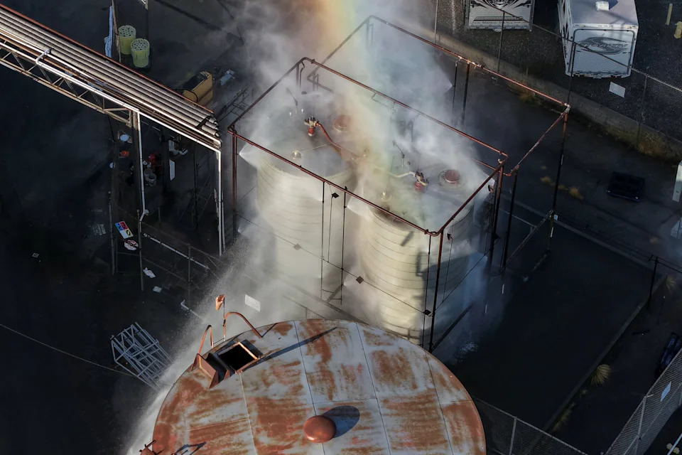 A drone picture shows water being sprayed on a tank as a chemical incident involving a failing tank of flammable liquid called methyl methacrylate, used in the aerospace industry, has forced an evacuation in the surrounding area in Garden Grove, California, U.S. May, 22, 2026.