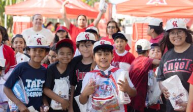 Orange County Superintendent of Schools Dr. Stefan Bean, Orange County District Attorney Todd Spitzer, OC GRIP representatives, students and school staff pose for a photo during a mentorship event at Angel Stadium on May 19.