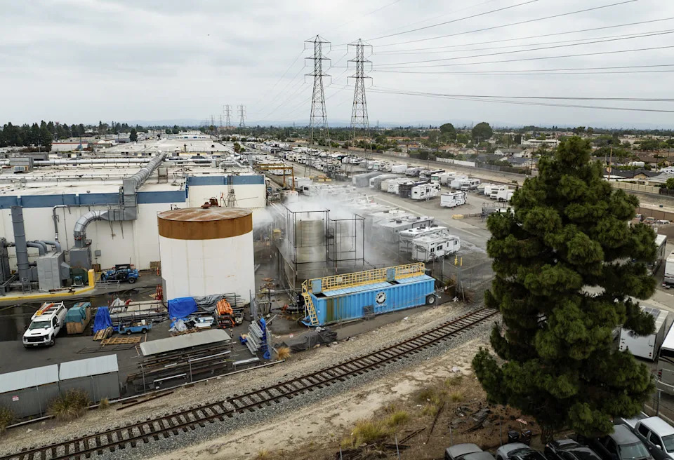 A drone photo of an industrial yard surrounded by train tracks. (Kayla Bartkowski / Los Angeles Times via Getty Images)