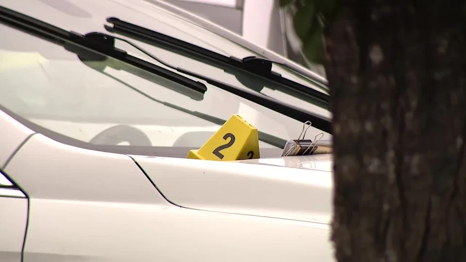 <div>Oakland police investigate after officer shoots suspect in the 1200 block of 9th Avenue. An evidence marker sits on the white suspect car. May 8, 2026</div>