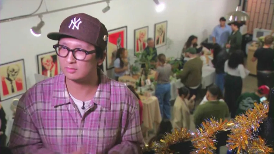 Tommy Le speaks with KTLA as customers enjoy drinks at Reinne's Place, a coffee shop dedicated to Le's late girlfriend, Reinne Lim. (KTLA)
