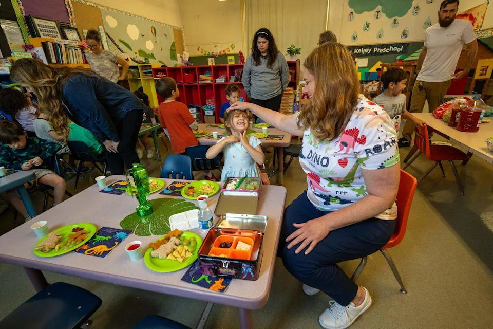 Teacher Amanda Chapman gently pats Natalie, 4, during a snack break at Edward Kelley parent participation preschool in Rosemont on Thursday. “People refer to this as a magical place for a child to be, and it truly is,” Chapman said. The school is facing closure because of budget cuts.
