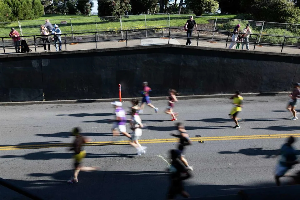 Runners descend Alamo Square during the 113th annual Bay to Breakers in San Francisco on Sunday. (Benjamin Fanjoy/For the S.F. Chronicle)