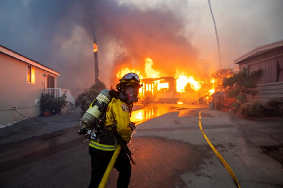 Firefighters work to extinguish the fire. REUTERS